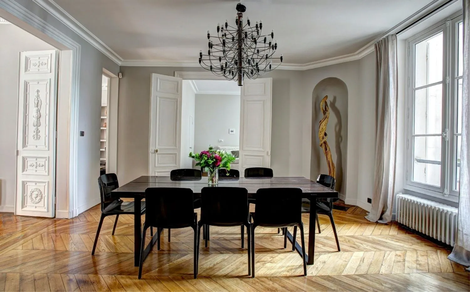 Modern interior design studio workspace featuring color swatches, mood boards, and email marketing analytics on screen